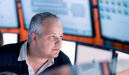 Image of a man looking at different screens