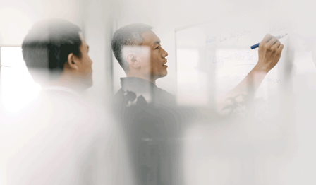 Men writing on whiteboard