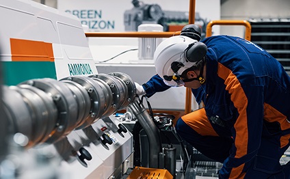 Wärtsilä employee works on an engine