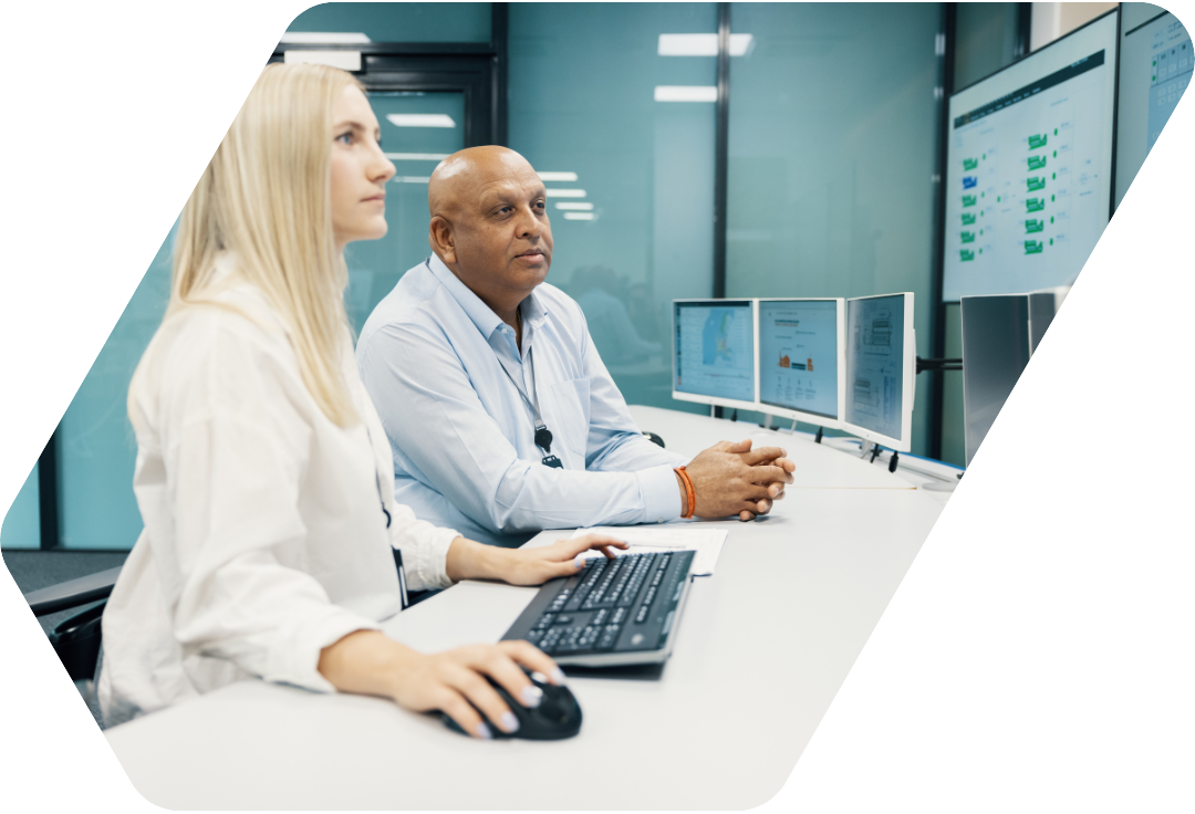Two people sitting in front of a computer