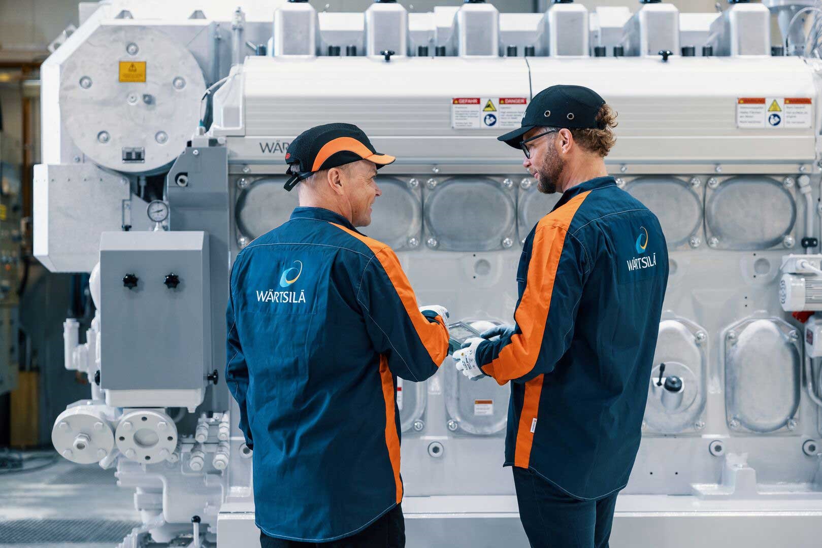 Engineers next to engine