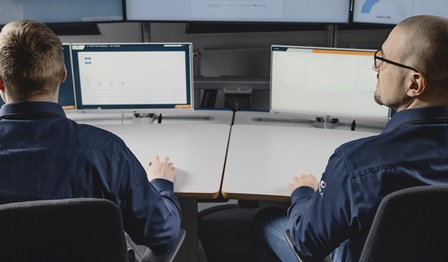 Two Wärtsilä specialists examine operational data provided virtually.