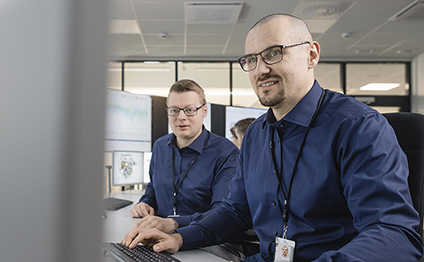 Wärtsilä employees sitting in front of a screen